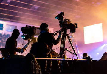 A group of cameramen working during the concert.