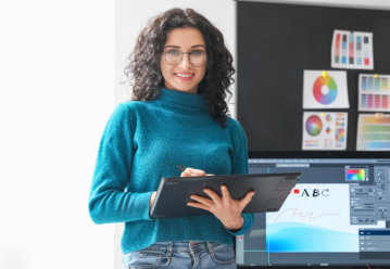 Young female designer working in office